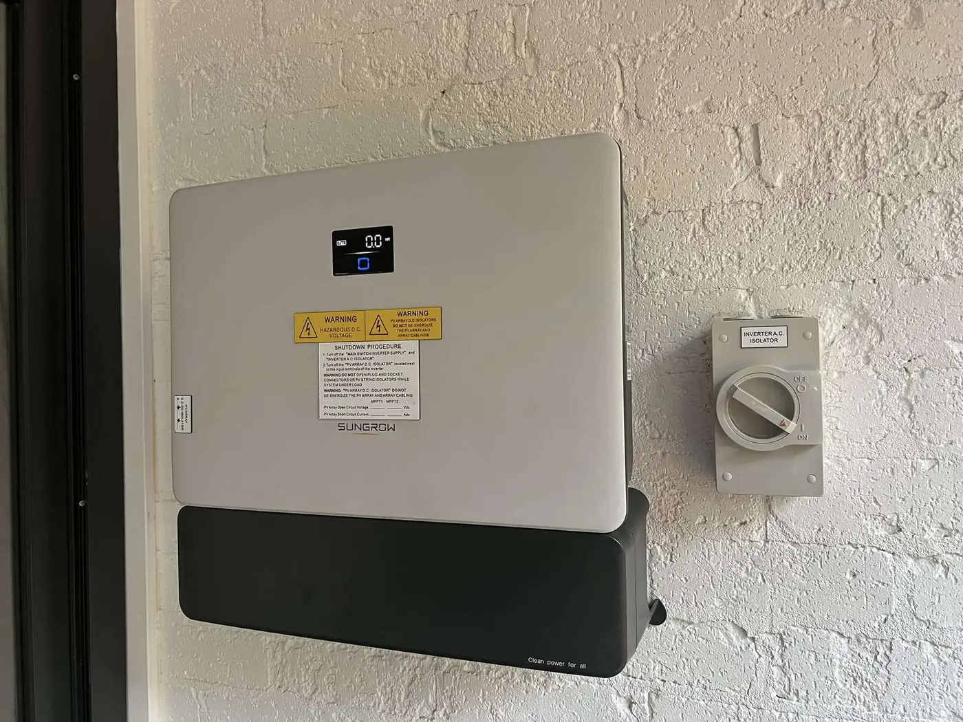 Hybrid inverter and battery installed on a rendered wall by Venux Electrical