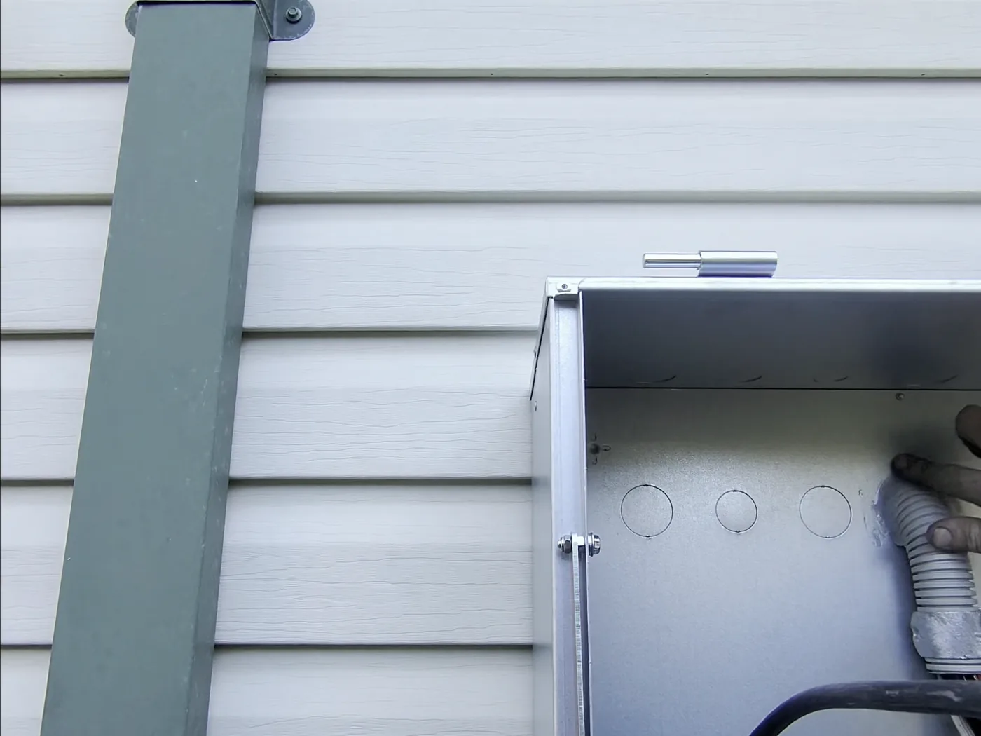 Venux electrician working at an overhead property service connection